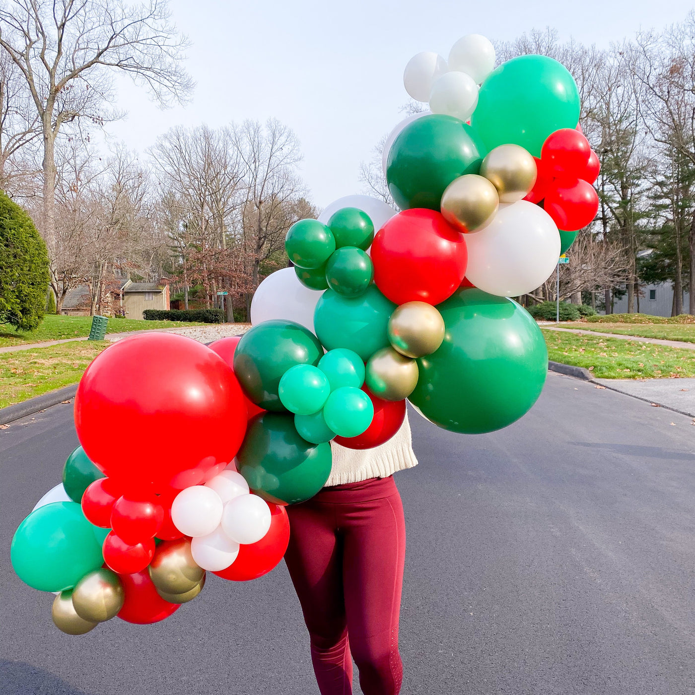 DIY Balloon Garland Kit in classic Christmas colors of red, white, green, and gold 