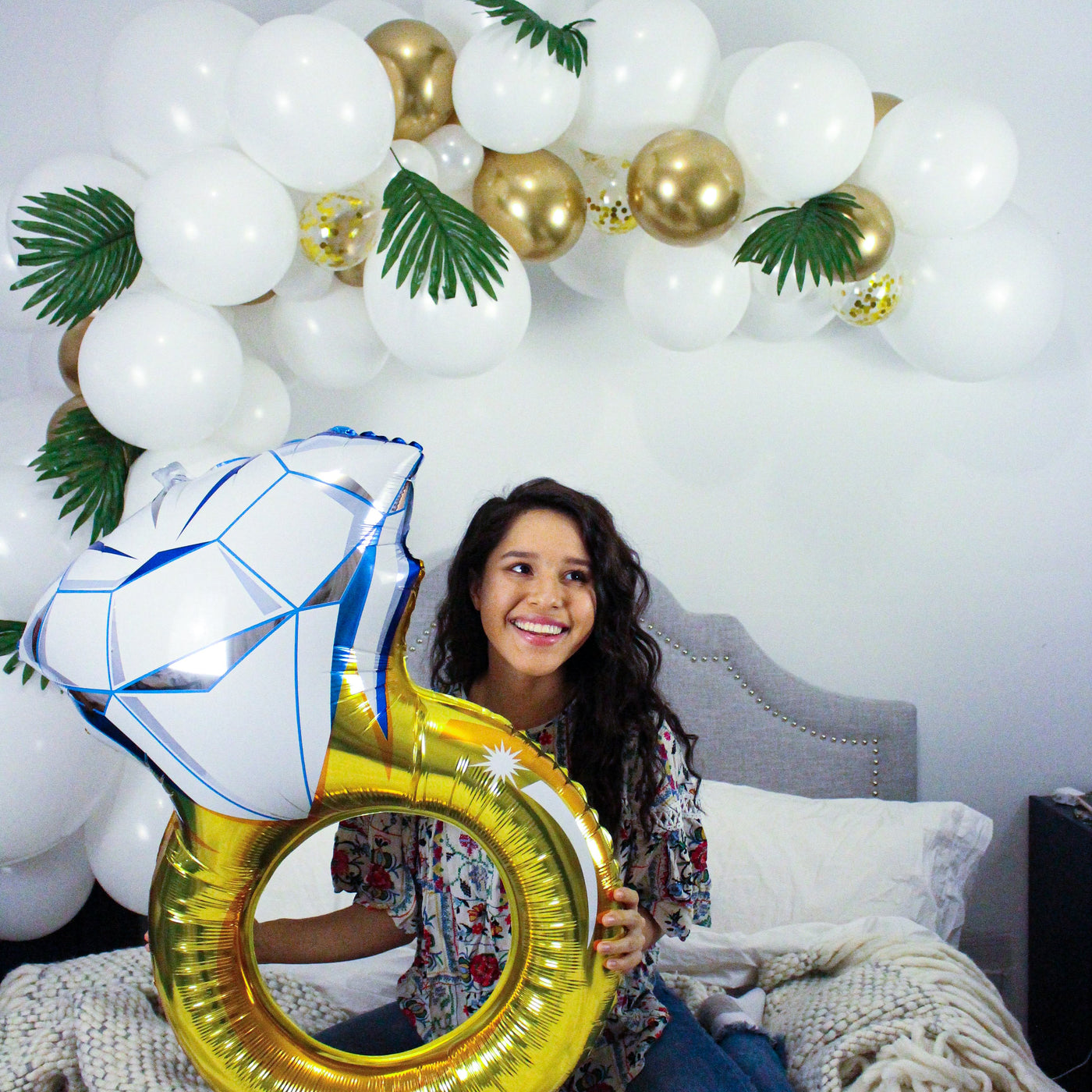 DIY Balloon Garland in White & Gold including balloons colored white, gold, and clear with gold confetti