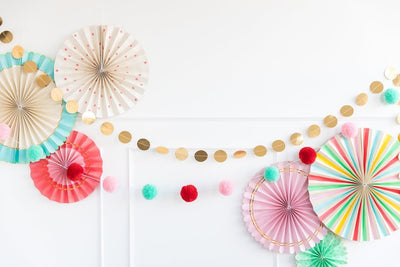 Festive holiday pom pom garland wall hung and paired with other party decorations