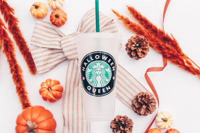 A frosted white reusable plastic Venti Starbucks cup with the Starbucks logo that reads Halloween Queen