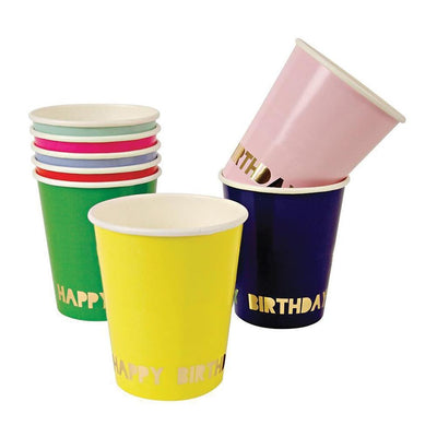 Happy birthday cups in a variety of bold colors stacked amongst each other with a 'happy birthday' greeting inscribed in gold near the bottom of the cup 