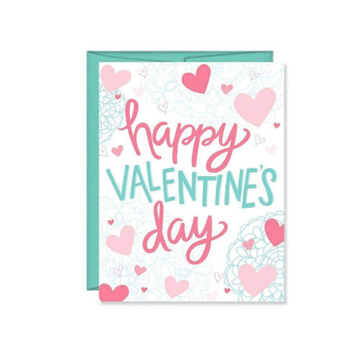 A traditional happy valentines day greeting card set on white paper with hearts and the words 'happy valentines day' accompanied by a teal colored envelope.