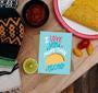 I love you more than tacos card displayed on a table with other party favors
