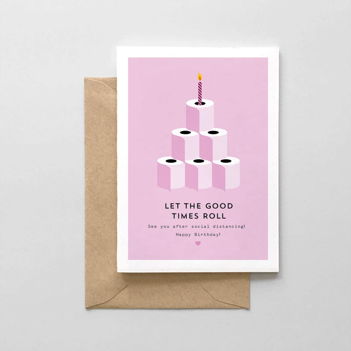 A birthday card printed on brilliant white card stock with the image of a toilet paper pyramid with candle on top printed in pink and the words below 'Let the Good Times Roll, See You After Social Distancing, Happy Birhtday'