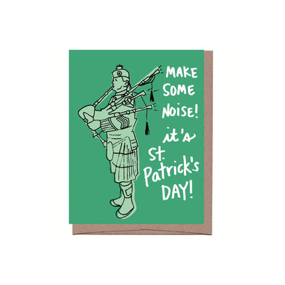 A St. Patrick's Day Greeting Card featuring a bagpipe player on a green card with the words 'make some noise! it's St. Patrick's Day!'