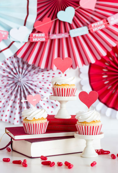 Cupcakes made with the valentine's day cupcake kit surrounded by Valentine's themed decorations