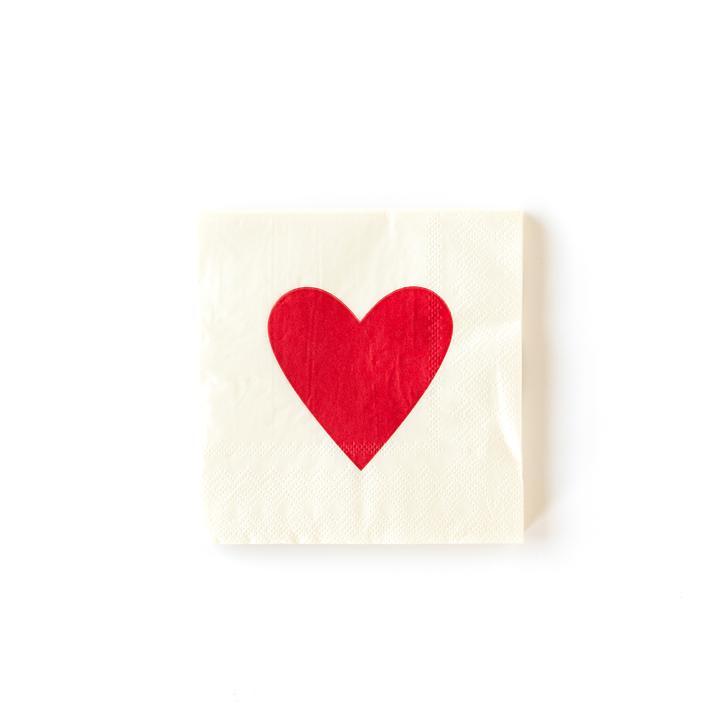 A white Valentine's day themed napkin with a large red heart in the center