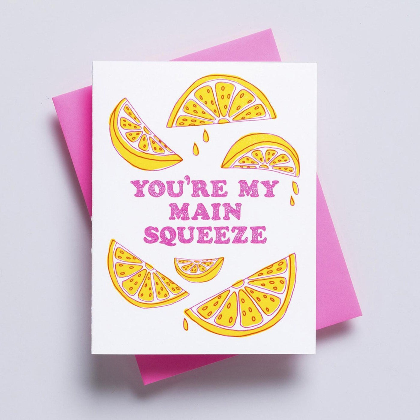 A cute white greeting card with the words 'you're my main squeeze' written in pink and surrounded by dripping lemon slices