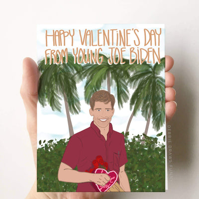 A Valentine's day greeting card featuring a cartoon image of young Joe Biden in a tropical vacation setting with the words 'Happy Valentine's Day From Young Joe Biden'